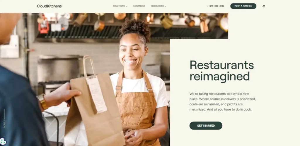 Chef hands takeout bag to delivery person, showcasing CloudKitchens' reimagined ghost kitchen concept.