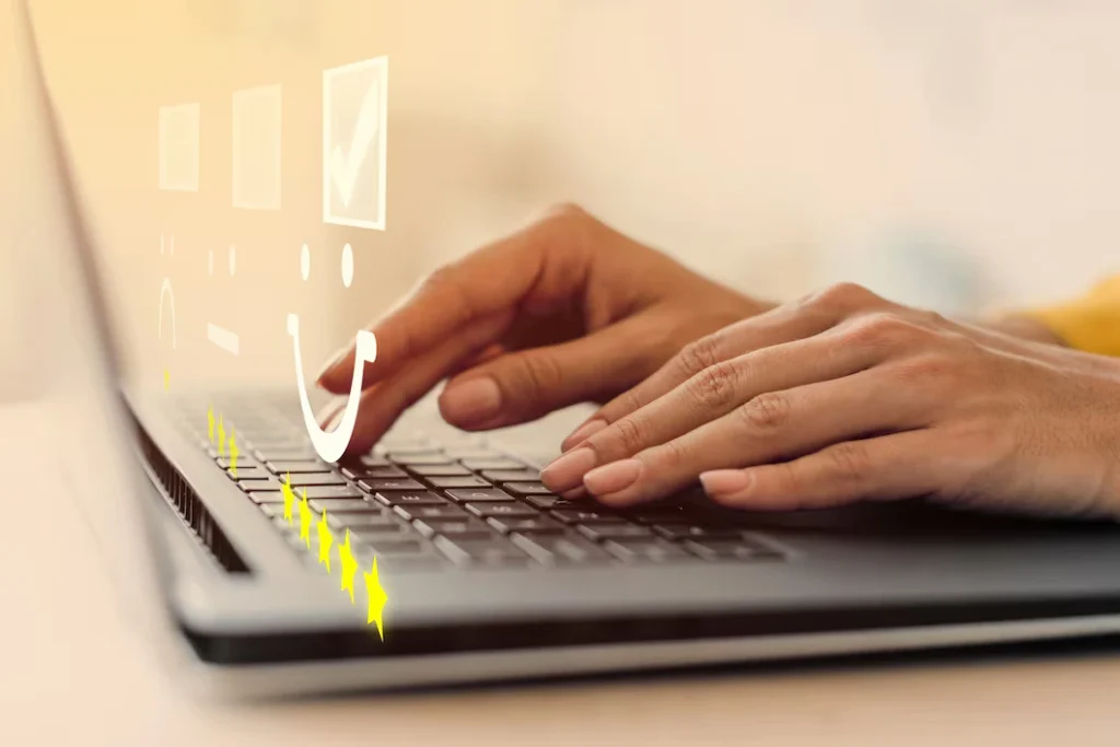 Hands typing on laptop keyboard, leaving online reviews for a restaurant with positive checkmarks floating above.