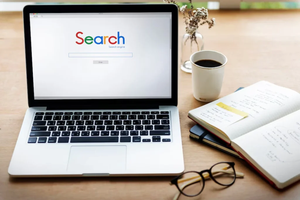 Laptop showing search engine homepage - researching best ways to market a restaurant and setting up a website.