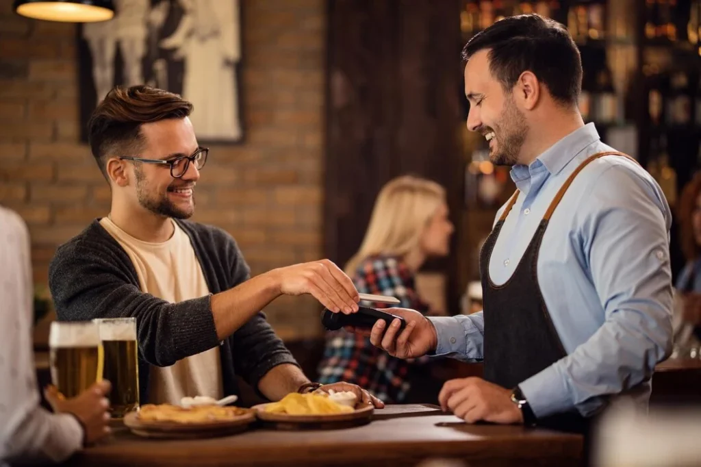 a waiter greeting a guest
