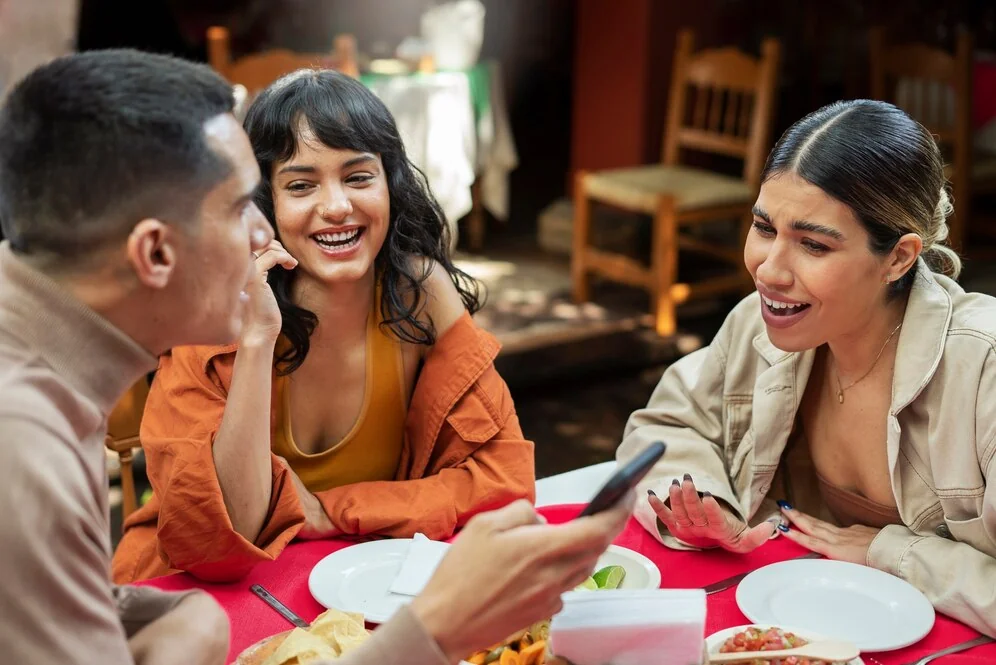 a group of friends enjoying Mexican food, discussing marketing ideas for small restaurants